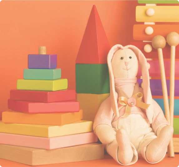 Colorful building blocks and a soft bunny toy, symbolizing the journey of building a family and hope