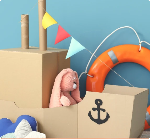A toy bunny in a cardboard boat with an anchor, representing navigating the fertility journey with support