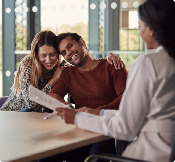A couple smiling while checking some documents