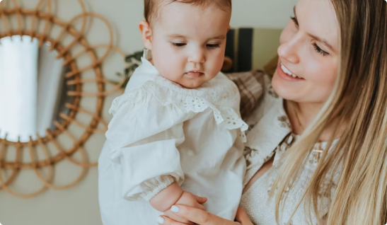 A woman gently holds her new IVF baby