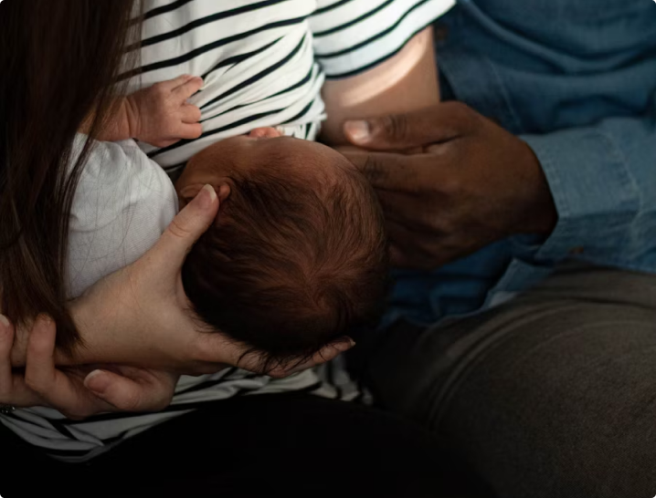 A woman breastfeeds her baby